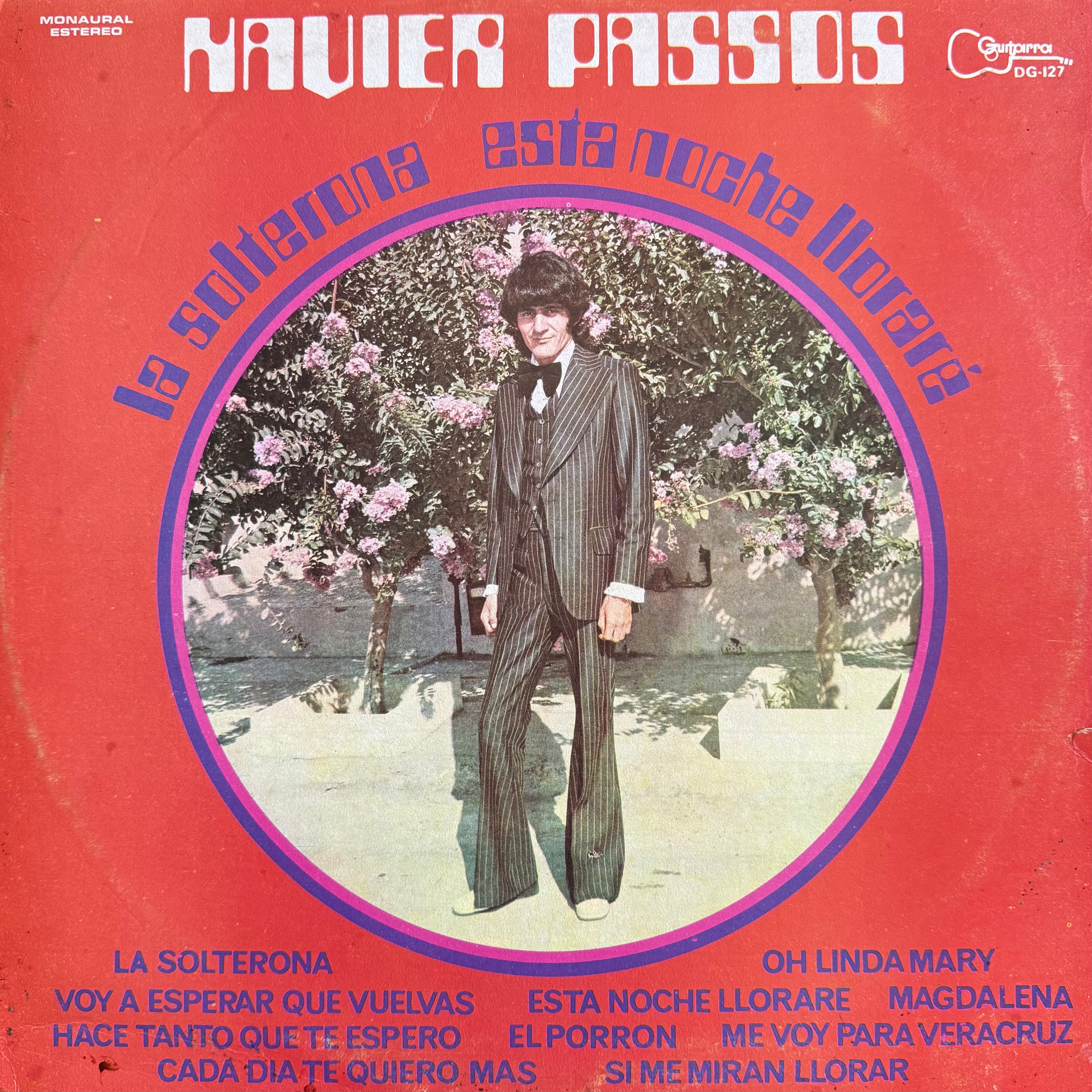 Vinyl record cover for 'La Soltera' by Navier Passos, featuring a central photo of a man in a pinstripe suit standing in front of flowering trees, set against a bright red background with blue and white text.